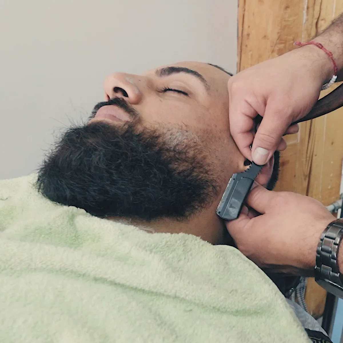 Barber lining a client's beard with a straight razor at Studio AZ Barbershop in the North Loop, Minneapolis